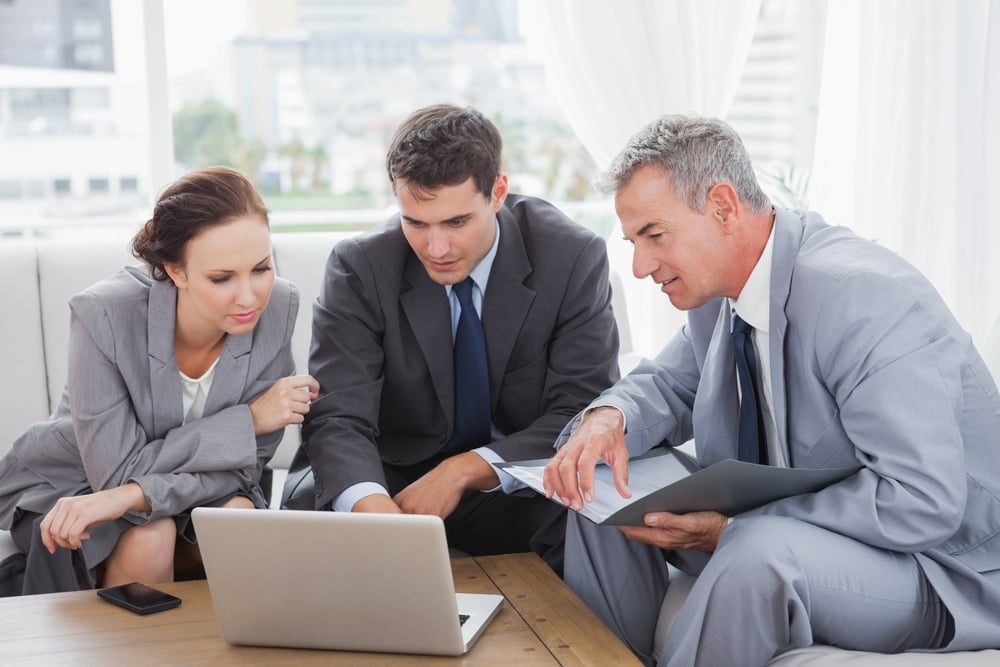 Business people working together on their laptop with ERP software