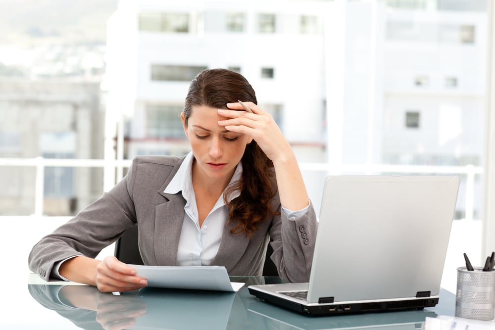Businesswoman reviewing errors from manually entered data in QuickBooks.