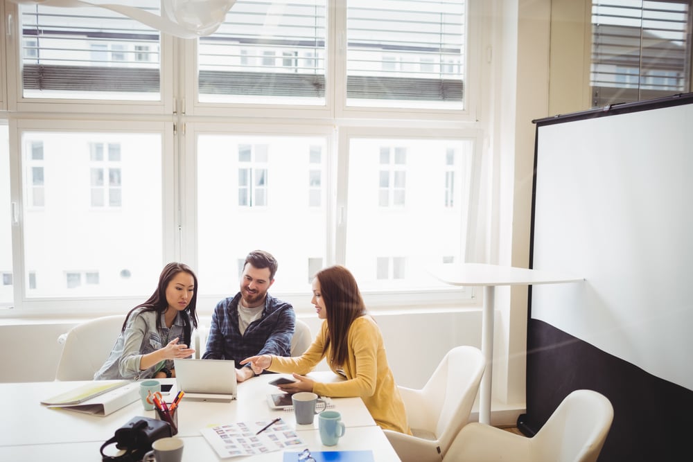 Professionals meeting to discuss plans to switch to a cloud ERP solution.
