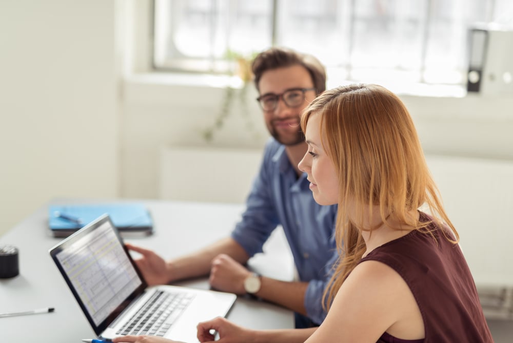 Businesspeople comparing ERP solutions for best fit.