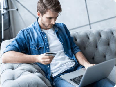 man shopping online with credit card