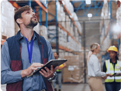 man in warehouse using mobile ERP system